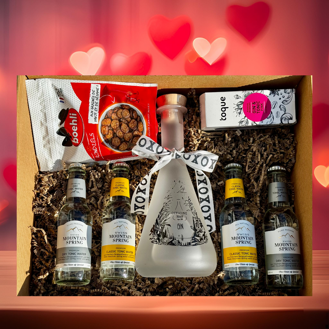 Bouteille de Gin Phi avec ruban XOXO – Cadeau idéal pour la Saint-Valentin, accompagné de tonics Swiss Mountain Spring et garnitures Pink Botanicals.